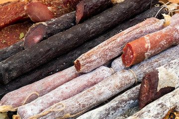 Many different smoked sausages in the store, close-up