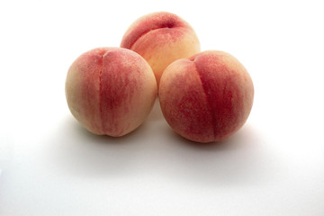 Three peaches on a white background isolated.