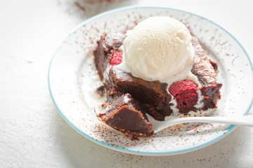 Raspberry chocolate brownies with vanilla ice creams 