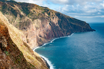 Fototapeta na wymiar The sun plays on the red cliffs of the west coast of Madeira Island