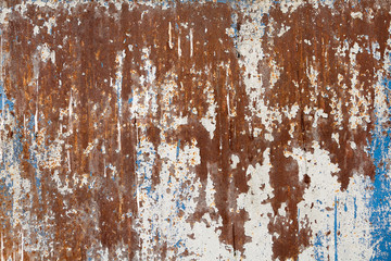 Surface of rusty metal wall with shabby blue paint.