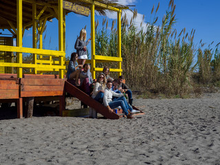 Group of friends having fun on autumn day at beach