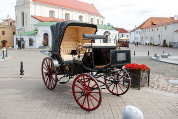 An old carriage in a modern city
