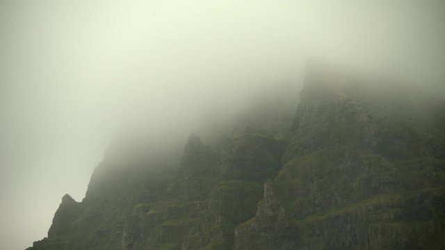 Fog rolling over rugged misty mountains, Iceland overcast day.mov