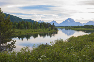Fototapeta na wymiar Reflection of the Grand Tetons in the Snake River viewing from Oxbow bend at Grand Teton National Park at sunset