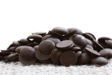 Pile of dark chocolate chip on white background.