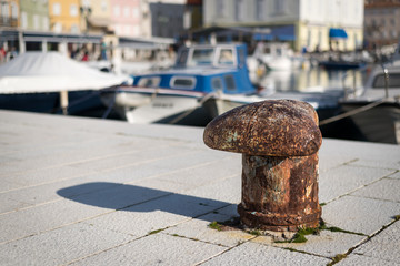 Rusty bollard in the harbour of Cres