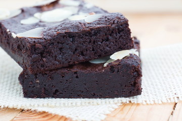 Dark chocolate brownies with almond topping, close up shot.