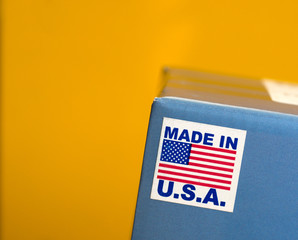 Made In U.S.A. Emblem On Blue Box Against Yellow Background - obrazy, fototapety, plakaty