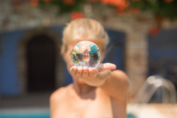 girl holding a crystal ball in her hand