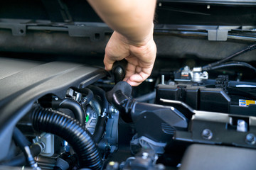 Professional mechanics  checking or fixing the engine of a modern car. mechanic performing maintenance and car maintenance.