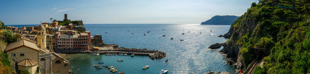 Fototapeta premium Panoramic View of the Bay in front of the Town of Vernazza on Blue Sky Background
