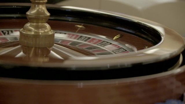 Spinning roulette gambling table with white ball in smotion. in casino. Gaming table in casino.