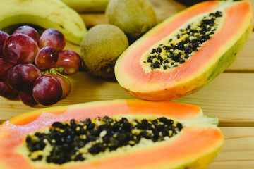 Group of fruits papaya, grape, kiwi and bananas