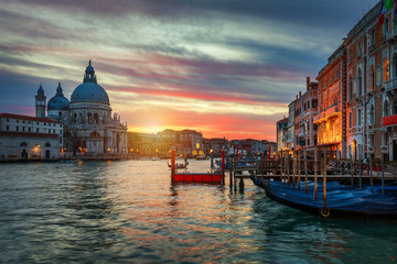 Sunset in Venice. Image of Grand Canal in Venice, with Santa Maria della Salute Basilica in the background. Venice is a popular tourist destination of Europe. Venice, Italy. - obrazy, fototapety, plakaty
