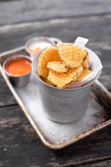 Close up on deep fried pickle slices in an old metal container