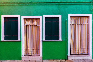 Colorful window of a house on the Venetian island of Burano, Venice. Facade of the houses of Burano close-up. Venice, Italy.