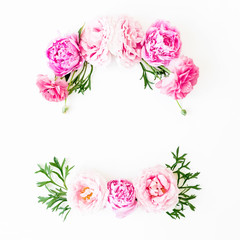 Floral frame made of rink roses and green leaves on white background. Flat lay, top view. Flower background