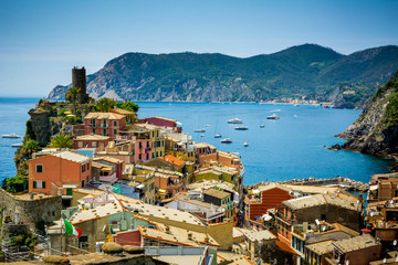 Horizontal View of the Town of Vernazza on blue Sea and the Coastline of the Liguria Background.