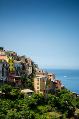 Fototapeta na wymiar Vertical View of the city of Corniglia on Blue Sky and Sea Background in the Italian National Park of the Cinque Terre.