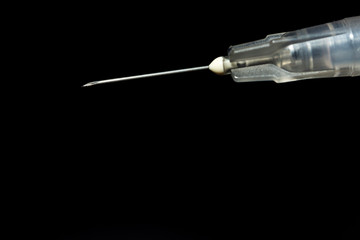 Syringe, injection needle on black background