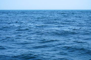 blue ocean and wave ripple with horizon line as background 