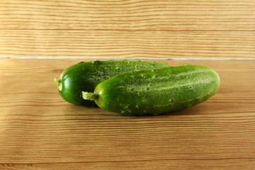 isolated green garden fresh cucumber on wooden background