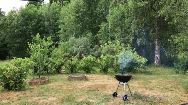 Charcoal buring in barbeque in the backyard