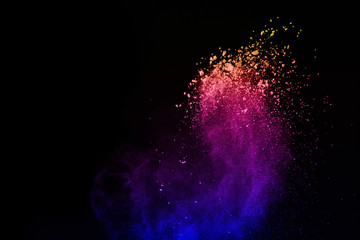 Multicolor powder explosion on black background. Colored cloud. Colorful dust explode. Paint Holi.