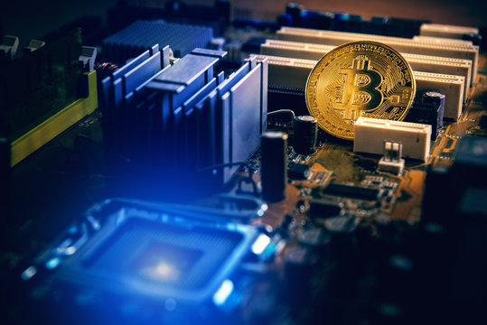 Golden bitcoin cryptocurrency on computer electronic circuit board, Business financial concept