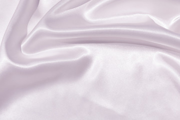 The texture of the satin fabric of lilac color for the background