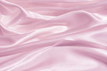 The texture of the satin fabric of pink color for the background 