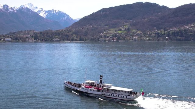 Large boat sailing across lake in Italy