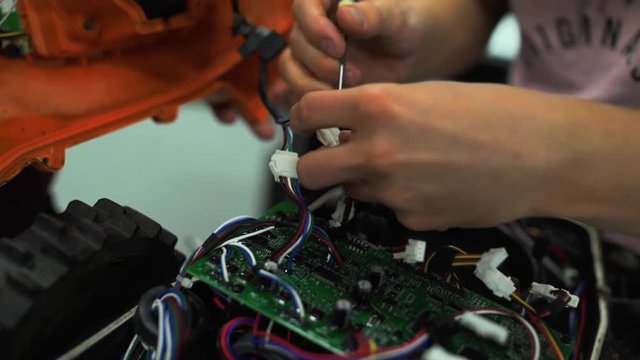 Repairing a mechatronic device. Disassembling the robot for repairs.