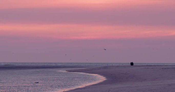 Gold hour sunset in Denmark Scandinavia Europe on beach with people walking