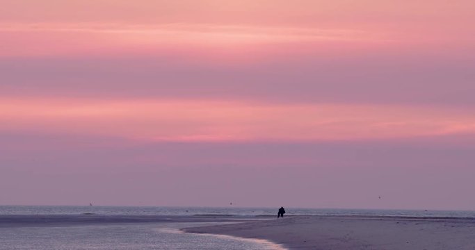 Gold hour sunset in Denmark Scandinavia Europe on beach with people walking