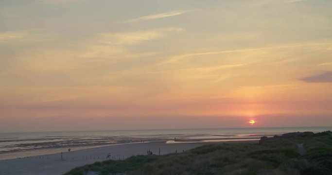 Gold hour sunset in Denmark Scandinavia Europe on beach with people walking