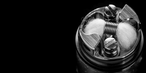 black and white, monochrome shot of single micro coil with japanese organic cotton wick in high end rebuildable dripping tank atomizer for flavour chaser, vaping device, vape gear, vaporizer equipment