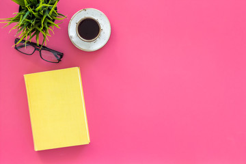 Reading for study and work. Self-education concept. business literature. Books with empty cover near glasses, coffe, plant on pink desk top view copy space