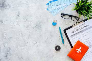 Documents for travel abroad. Visa application form, pen, passport cover with airplane silhouette,...