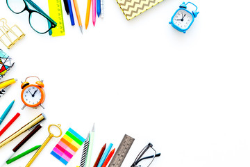 Student accessories. Stationery mockup with glasses, alarm clock, notebook on white background top view copy space