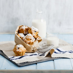 Fresh homemade cupcakes with raisins, powdered sugar and milk