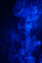 Blue smoke on black background.