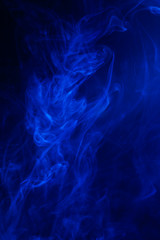 Blue smoke on black background.