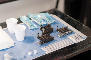 Tattoo machines on blue work station