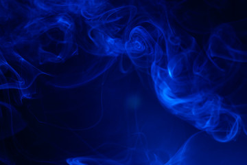 Blue smoke on black background.