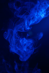 Fototapeta premium Blue smoke on black background.