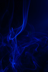 Blue smoke on black background.