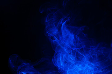 Blue smoke on black background.