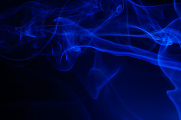 Blue smoke on black background.